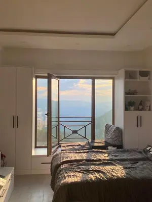 a bedroom with a bed and a large window at Pahuljica - N25 Milmari in Raška