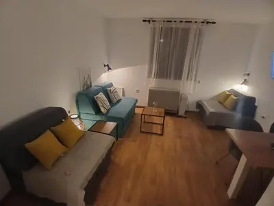 a living room with a couch and two chairs at Bela reka Gondola Studio in Brzeće