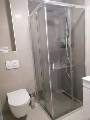 a shower stall in a bathroom with a toilet at Cloud in Niš
