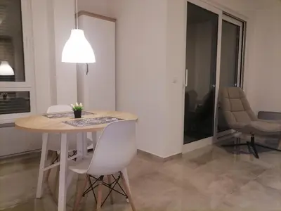 a dining room with a table and chairs at Cloud in Niš