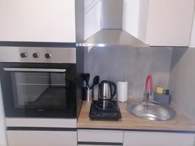 a kitchen counter with a sink and a microwave at Cloud in Niš