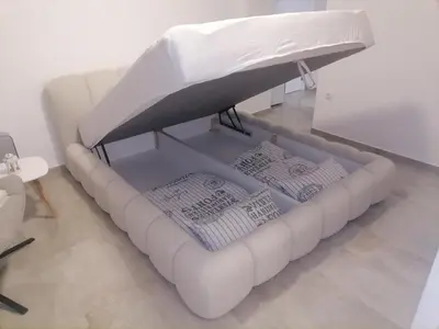a white couch with a bed in a room at Cloud in Niš