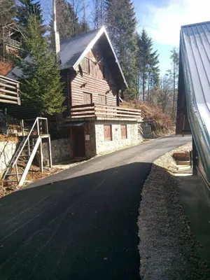 an empty road in front of a wooden house at Mountain home Borut in Kopaonik