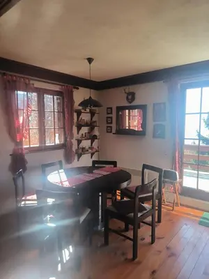 a dining room with a table and chairs at Mountain home Borut in Kopaonik