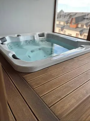 a bath tub sitting on top of a wooden cabinet at Apartman Harmonija in Kopaonik