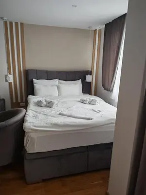 a bed with two stuffed animals on top of it at Apartman Harmonija in Kopaonik