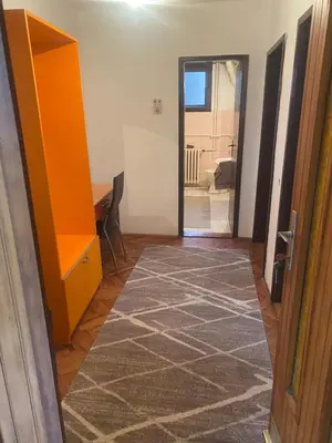 a room with a hallway with a door and a rug at Apartman Mina in Kuršumlija