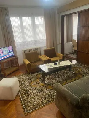 a living room with a couch and a coffee table at Apartman Mina in Kuršumlija