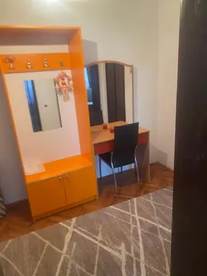 a room with a mirror and a desk with a chair at Apartman Mina in Kuršumlija