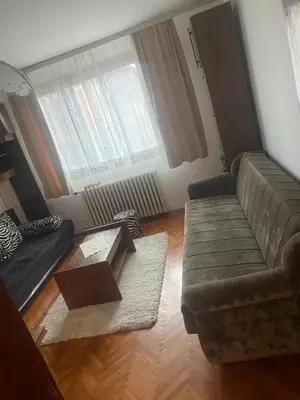 a living room with a couch and a coffee table at Apartman Mina in Kuršumlija