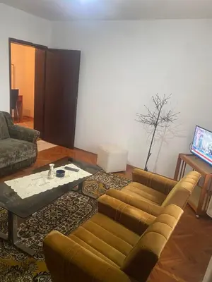 a living room with a couch and a coffee table at Apartman Mina in Kuršumlija
