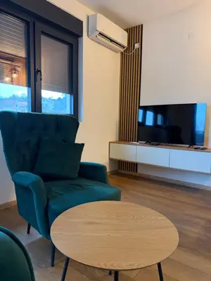 a living room with a couch and a table at Emerald Residence in Vrnjačka Banja
