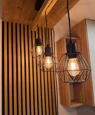 a group of three lights hanging from a wall at Emerald Residence in Vrnjačka Banja