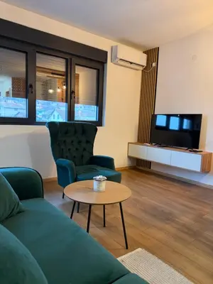a living room with a couch and a table at Emerald Residence in Vrnjačka Banja