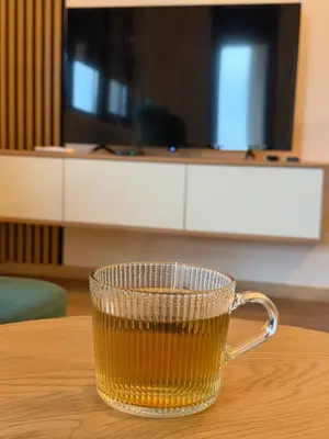 a glass cup of beer sitting on a table at Emerald Residence in Vrnjačka Banja
