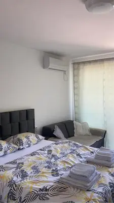 a bedroom with a bed with a blanket on it at Apartman studio BMB 1 in Bukorovac