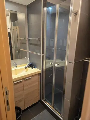 a bathroom with a shower and a sink at Cetar slope 2 apartman in Kopaonik