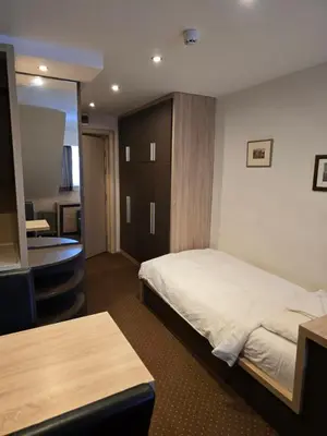 a hotel room with a bed and a mirror at Cetar slope 2 apartman in Kopaonik