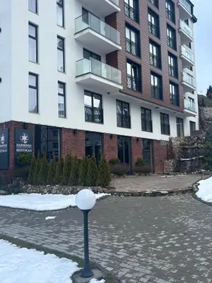a building with a parking meter in front of it at Apartman u hotelu Harmonija Palace Kopaonik in Kopaonik
