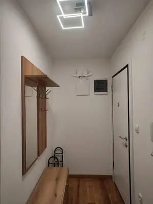 a room with a mirror and a wooden table at D&D Apartment in Vrnjačka Banja