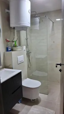 a bathroom with a toilet and a glass shower at Apartmani Maša Kopaonik in Kopaonik