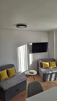 a living room with a couch and a table at Apartmani Maša Kopaonik in Kopaonik