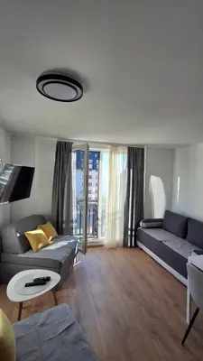 a living room with a couch and a table at Apartmani Maša Kopaonik in Kopaonik