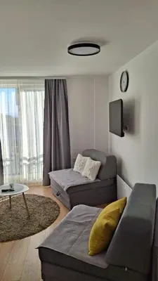 a living room with a couch and a table at Apartmani Maša Kopaonik in Kopaonik