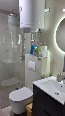 a bathroom with a toilet and a sink and a shower at Apartmani Maša Kopaonik in Kopaonik