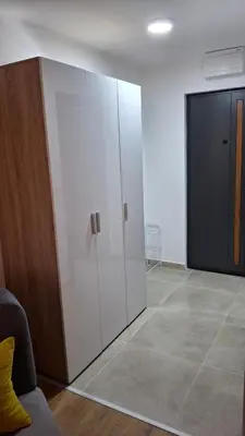 a large white cabinet in a room at Apartmani Maša Kopaonik in Kopaonik