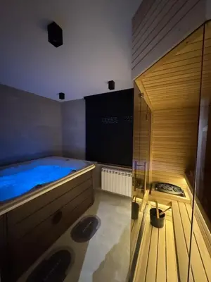 a sauna with a blue tub in a room at Tilia Lux apartmani in Bukorovac