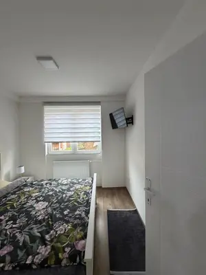a bedroom with a bed and a window at Apartman AURORA Trstenik in Trstenik