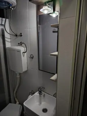 a small bathroom with a sink and a mirror at Ski in ski out Apartman in Kopaonik