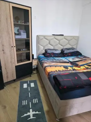 a bedroom with a bed and a cabinet at Pilot peak in Kopaonik
