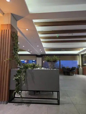 an office lobby with a bench with potted plants at Pilot peak in Kopaonik