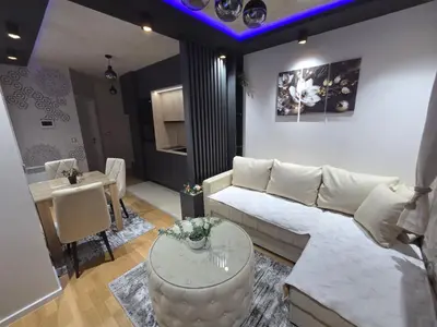 a living room with a couch and a table at Royal Lux in Vrnjačka Banja
