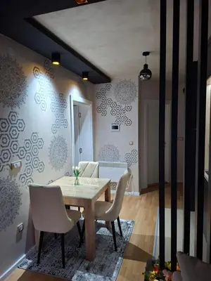 a dining room with a table and chairs at Royal Lux in Vrnjačka Banja