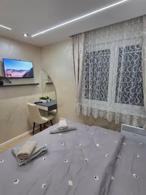 a bedroom with a bed and a desk and a television at Royal Lux in Vrnjačka Banja