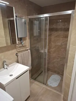 a shower with a glass door in a bathroom at Royal Lux in Vrnjačka Banja