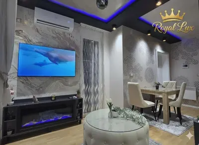 a living room with a dolphin on the wall at Royal Lux in Vrnjačka Banja