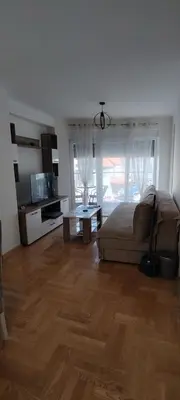 a living room with a bed and a table at Apartman CiricMDV in Vrnjci