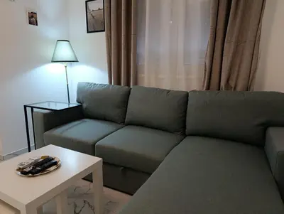 a living room with a couch and a table at Central lux in Ćuprija