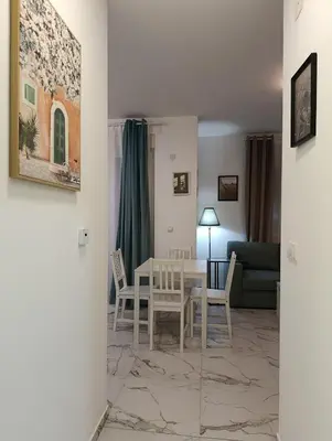 a living room with a table and chairs and a couch at Central lux in Ćuprija