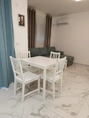 a white table and chairs in a living room at Central lux in Ćuprija
