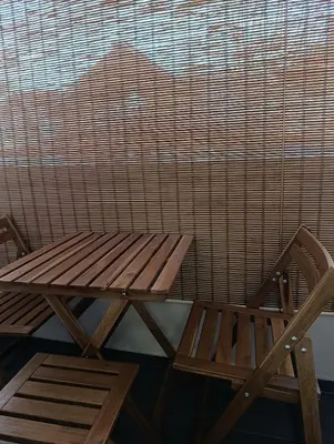 a wooden bench sitting next to a window at Central lux in Ćuprija