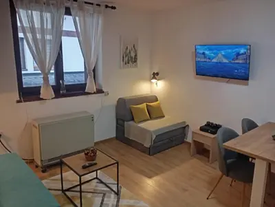 a living room with a couch and a chair at Gondola Lux Apartment in Brzeće