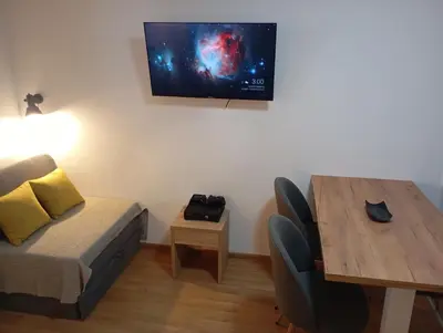 a living room with a couch and a table and a television at Gondola Lux Apartment in Brzeće