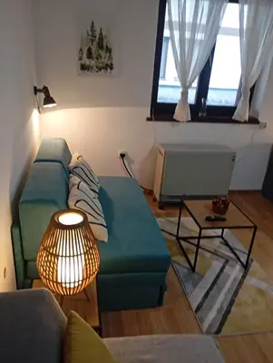 a living room with a couch and a table at Gondola Lux Apartment in Brzeće