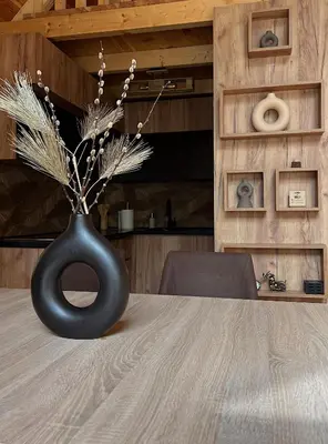 a black vase sitting on top of a table at Kaizen Cabin in Kursumlijska Banja