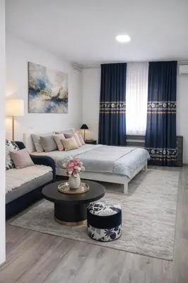 a living room with a bed and a couch at Apartmani NANA in Vrnjci